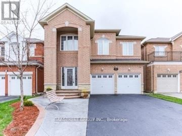 Brampton (Fletcher's Meadow) apartment for rent - A large brick house with a tree in front and a sign that says "REALTOR".