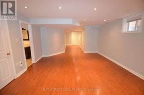Brampton (Fletcher's Meadow) apartment for rent - A spacious room with wooden floors and white walls.
