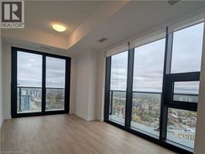 Kitchener condo for rent - A room with a view of the city through large windows.