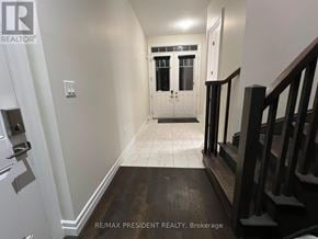 Hamilton (Stoney Creek Mountain) apartment for rent - A hallway with a white door and a black staircase.