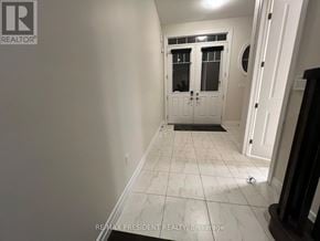 Hamilton (Stoney Creek Mountain) apartment for rent - A hallway with a black and white tiled floor and a white door.