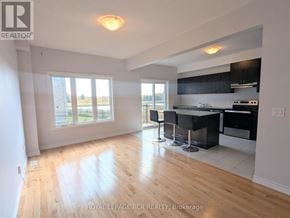 Southgate townhouse for rent - A well-lit kitchen and dining area with wooden floors and modern appliances.