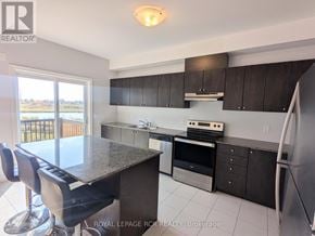 Southgate townhouse for rent - A kitchen with a granite countertop and stainless steel appliances.