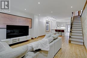 Toronto (East End-Danforth) apartment for rent - A living room with a white couch and a television.