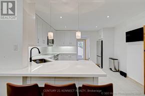 Toronto (East End-Danforth) apartment for rent - A modern kitchen with white cabinets and a large island.