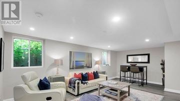 Ottawa apartment for rent - A living room with a white sofa and a wooden coffee table.