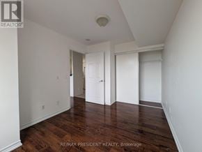Toronto (West Humber-Clairville) condo for rent - A room with wooden floors and white walls.
