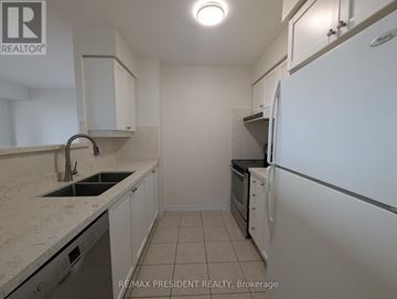 Toronto (West Humber-Clairville) condo for rent - A kitchen with white cabinets and a white refrigerator.