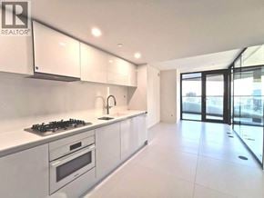 Vancouver apartment for rent - A modern kitchen with white cabinets and a gas stove.