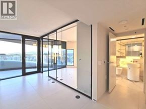 Vancouver apartment for rent - A modern bathroom with a glass door and a white counter.