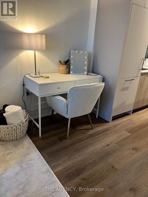 Toronto (Wychwood) condo for rent - A white desk with a chair and a basket on the floor.