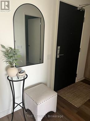 Toronto (Wychwood) condo for rent - A black door is in a white room.
