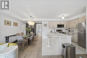 Barrie (Innis-Shore) condo for rent - A modern kitchen with a dining table and chairs.
