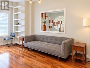 Mississauga (Cooksville) townhouse for rent - A grey couch sits in a living room with a painting on the wall.