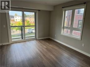 Kitchener apartment for rent - A room with a sliding glass door leading to a balcony.