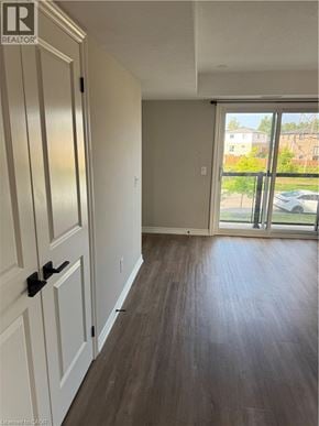 Kitchener apartment for rent - A room with a sliding glass door leading to a balcony.