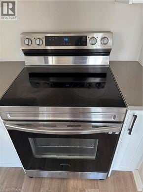 Kitchener apartment for rent - A stainless steel oven with a digital display and control panel on top.
