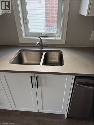 Kitchener apartment for rent - A kitchen with a sink and a window.