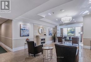 Richmond Hill (North Richvale) condo for rent - A living room with a fireplace and a painting on the wall.