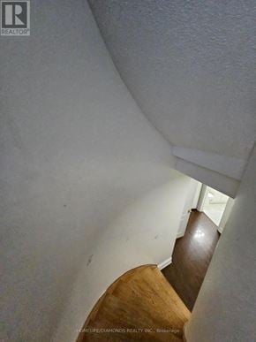 Brampton (Northwest Sandalwood Parkway) apartment for rent - A stairway with a white wall and wooden steps.