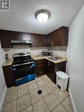 Brampton (Northwest Sandalwood Parkway) apartment for rent - A small kitchen with a sink, stove, and microwave.