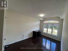 Brampton (Credit Valley) apartment for rent - A room with a stained glass window and wooden floors.