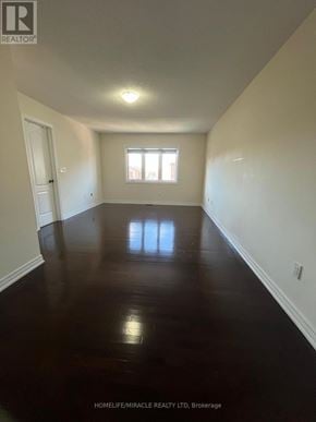 Brampton (Credit Valley) apartment for rent - A room with wooden floors and white walls.