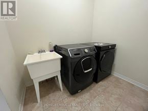 Brampton (Credit Valley) apartment for rent - A laundry room with a washer and dryer and a small white table.