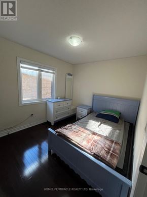 Brampton (Credit Valley) apartment for rent - A bedroom with a bed, dresser, and window.