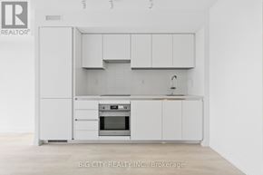 Toronto (Leaside) condo for rent - A white kitchen with a sink and cabinets.
