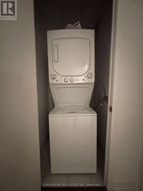 Toronto (South Parkdale) condo for rent - A white toilet with a tank and a door in the background.