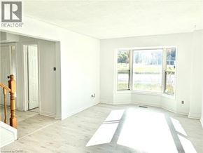 Grimsby apartment for rent - A room with a wooden staircase and white walls.
