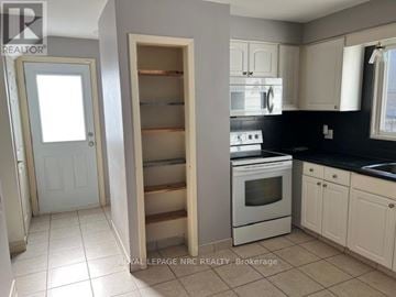 Niagara Falls (Morrison) apartment for rent - A kitchen with a white oven and black countertops.