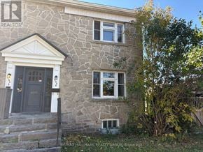 Ottawa apartment for rent - A stone house with a brown door and windows.