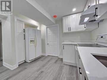 Whitby (Williamsburg) apartment for rent - A kitchen with white cabinets and a refrigerator.