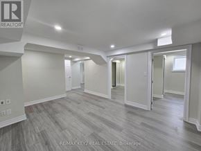 Whitby (Williamsburg) apartment for rent - A spacious room with wood flooring and white walls.