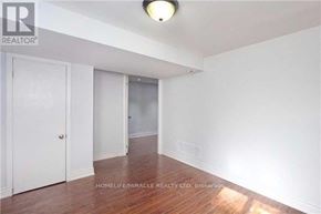 Brampton (Brampton North) apartment for rent - A room with wooden floors and white walls, with a door on the right and a window on the left.