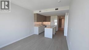 Burnaby apartment for rent - A realtor logo is on the wall of a spacious empty room.