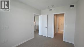 Burnaby apartment for rent - A realtor logo is on the wall of a white room.