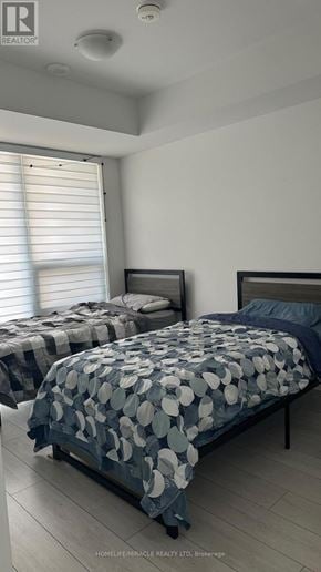 Toronto (Agincourt South-Malvern West) condo for rent - Two beds with blue and white bedspreads in a room.
