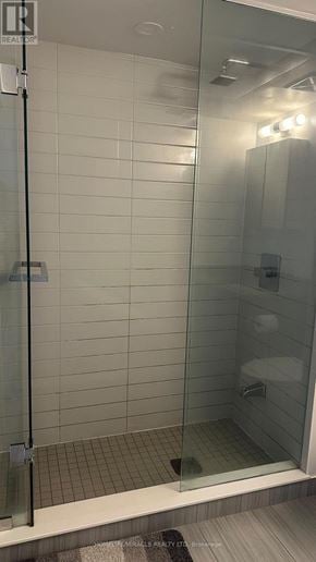 Toronto (Agincourt South-Malvern West) condo for rent - A shower with a glass door and a white tiled wall.