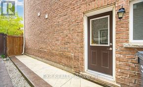 Caledon apartment for rent - A red brick house with a brown door and a small window above it.
