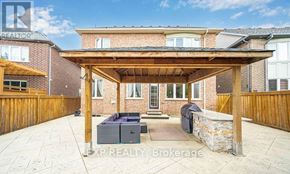 Caledon apartment for rent - A covered patio area with a couch and a table.