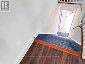 Toronto (Birchcliffe-Cliffside) apartment for rent - A stairway with a wooden floor and a metal railing.