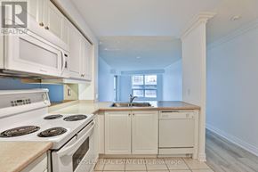 Toronto (Mimico) condo for rent - A kitchen with white appliances and cabinets.