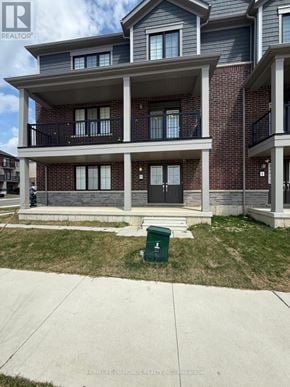 Haldimand townhouse for rent - A two-story brick apartment building with a balcony on the second floor.
