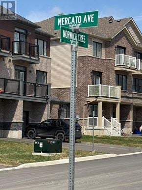 Haldimand townhouse for rent - A Mercato Ave street sign is in front of apartment buildings.