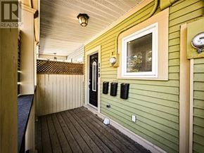St. John's multi-family for rent - A green house with a black door and a window.