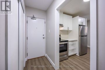 Aylmer fourplex for rent - A small kitchen with a refrigerator, oven, and microwave.
