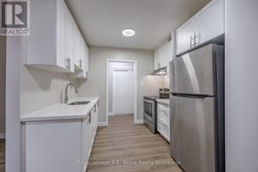 Aylmer fourplex for rent - A modern kitchen with white cabinets and stainless steel appliances.